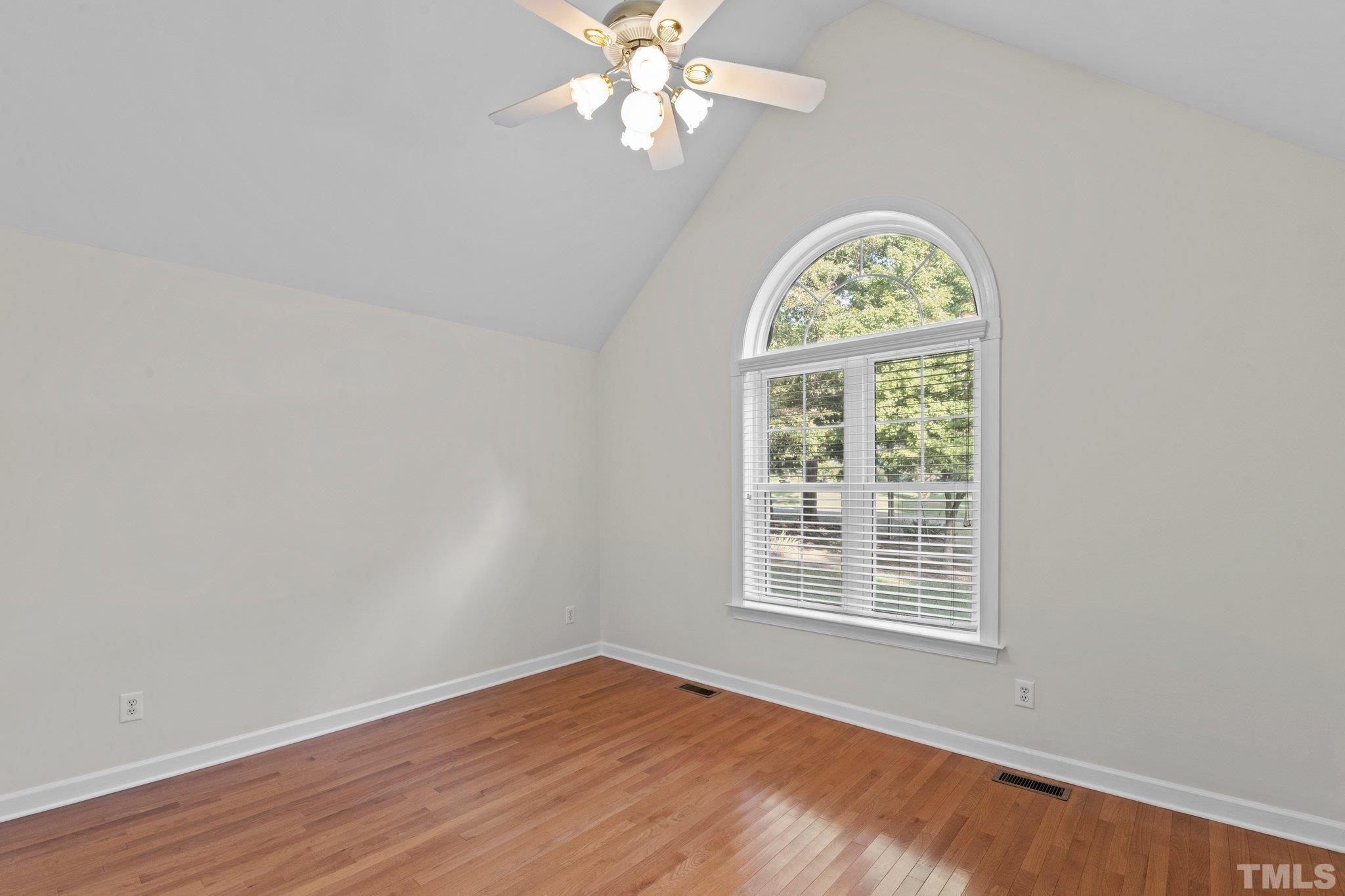 8025 Lockleair Road Zebulon, NC 27597 - Photo 22 of 30 Beautiful bedroom with massive palatium window for natural light, cathedral ceiling, spacious closet and fresh accent paint. Room could be used as bedroom, den or home office .