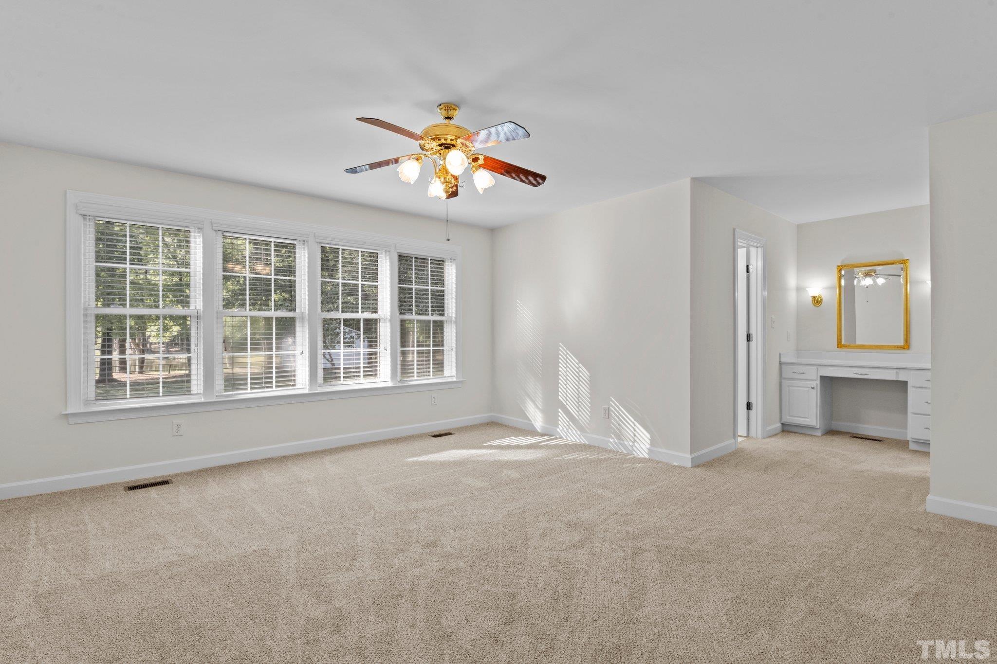 8025 Lockleair Road Zebulon, NC 27597 - Photo 24 of 30 Spacious Master bedroom can accommodate king sized furniture. Lots of natural light from wall of windows with views of back yard and neighboring pond. D Dressing area located between bath and walk-in-closet. Freshly painted