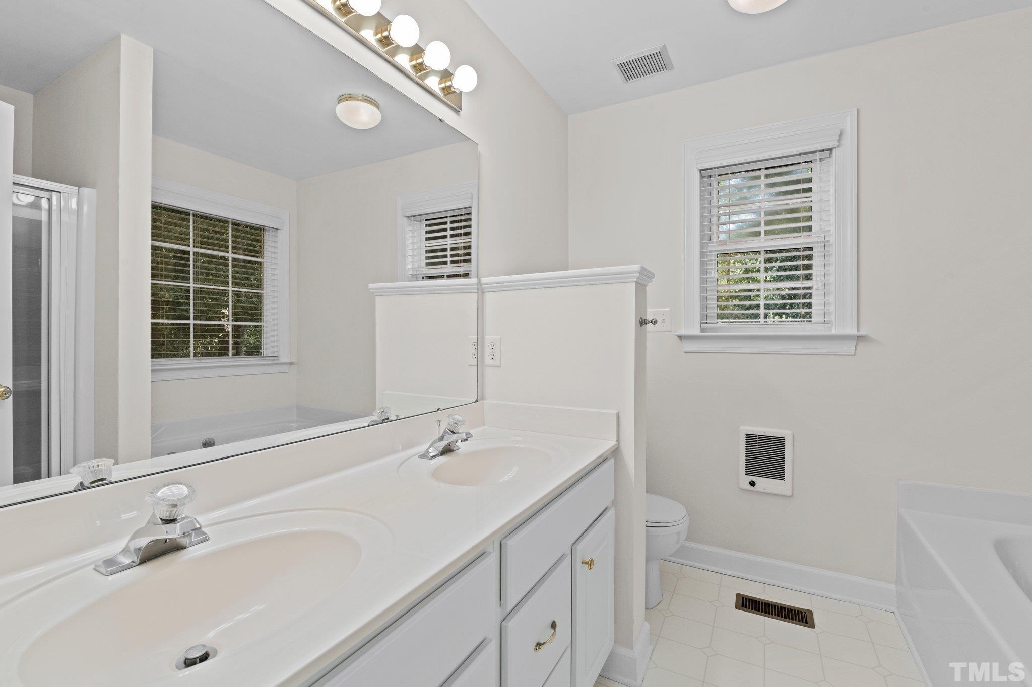 8025 Lockleair Road Zebulon, NC 27597 - Photo 27 of 30 Light airy bathroom with double vanity