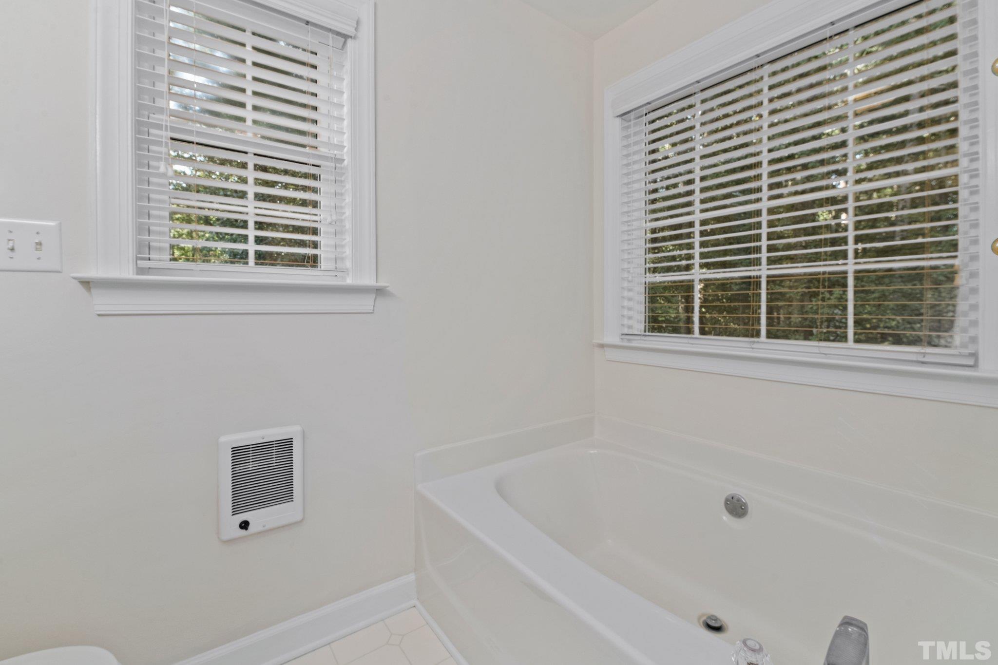 8025 Lockleair Road Zebulon, NC 27597 - Photo 28 of 30 Soaking tub with lots of windows for natural light. Separate shower with glass door. Double vanity.