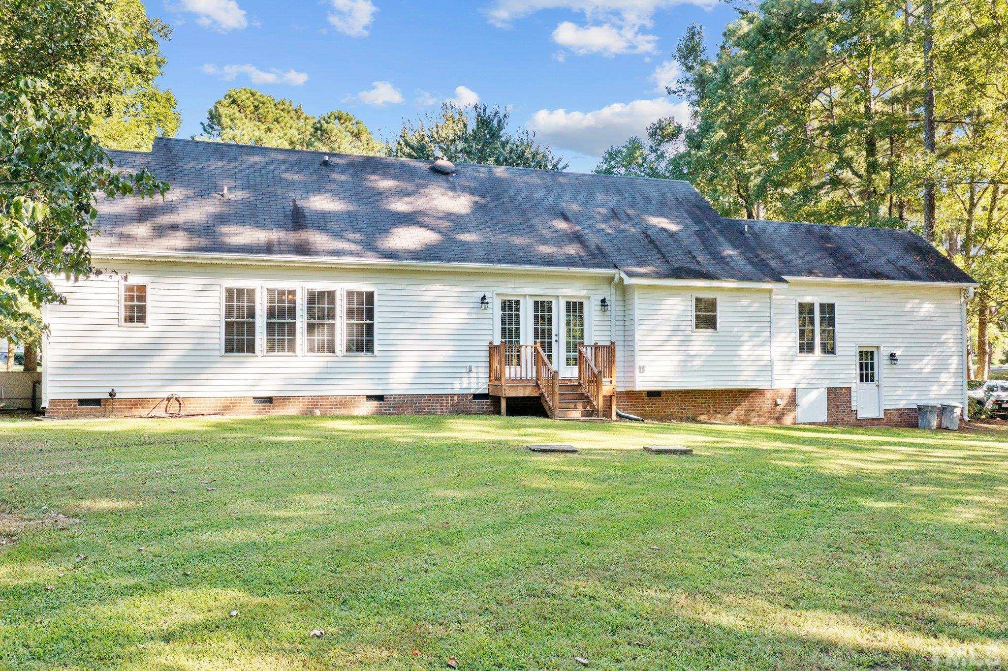 Back windows and doors all have spectacular views of shady back yard and neighboring pond