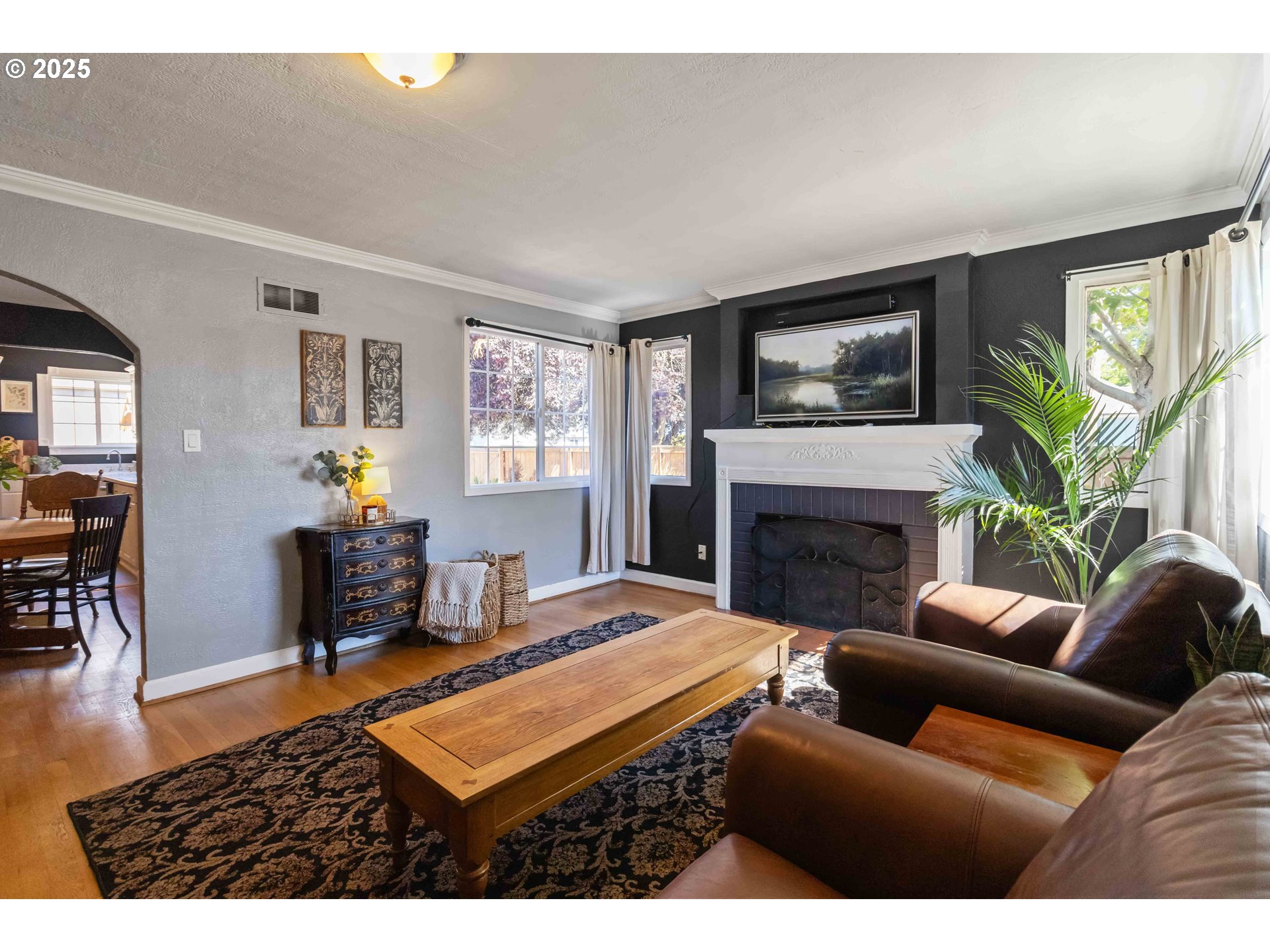 567 20th Avenue Longview, WA 98632 - Photo 6 of 41 a living room with furniture a flat screen tv and a fireplace