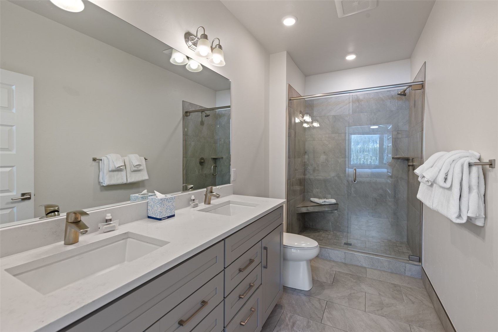 23 Clearwater Way, Unit 106 Keystone, CO 80435 - Photo 16 of 21 a spacious bathroom with a double vanity sink toilet and a mirror