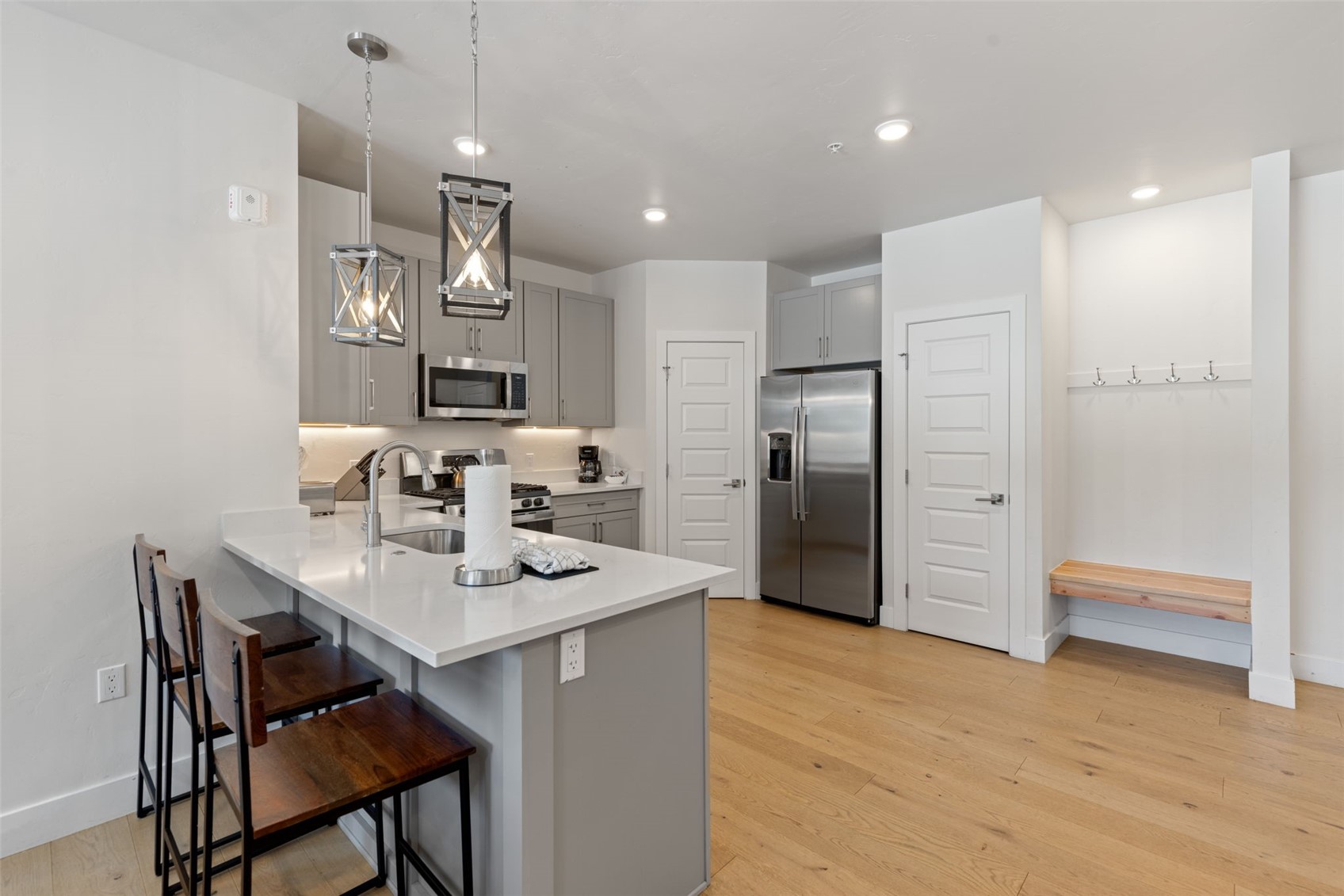 23 Clearwater Way, Unit 106 Keystone, CO 80435 - Photo 6 of 21 a kitchen with stainless steel appliances granite countertop a refrigerator a sink a stove a dining table and chairs