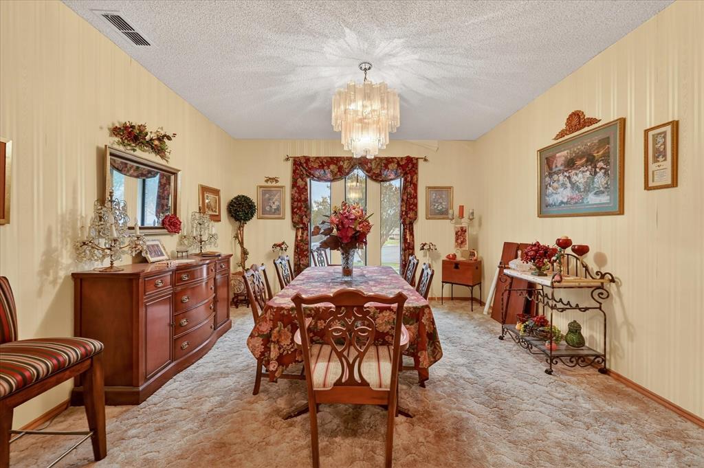 1605 Heather Court Cleburne, TX 76033 - Photo 11 of 33 a view of a dining room with furniture a chandelier and a window