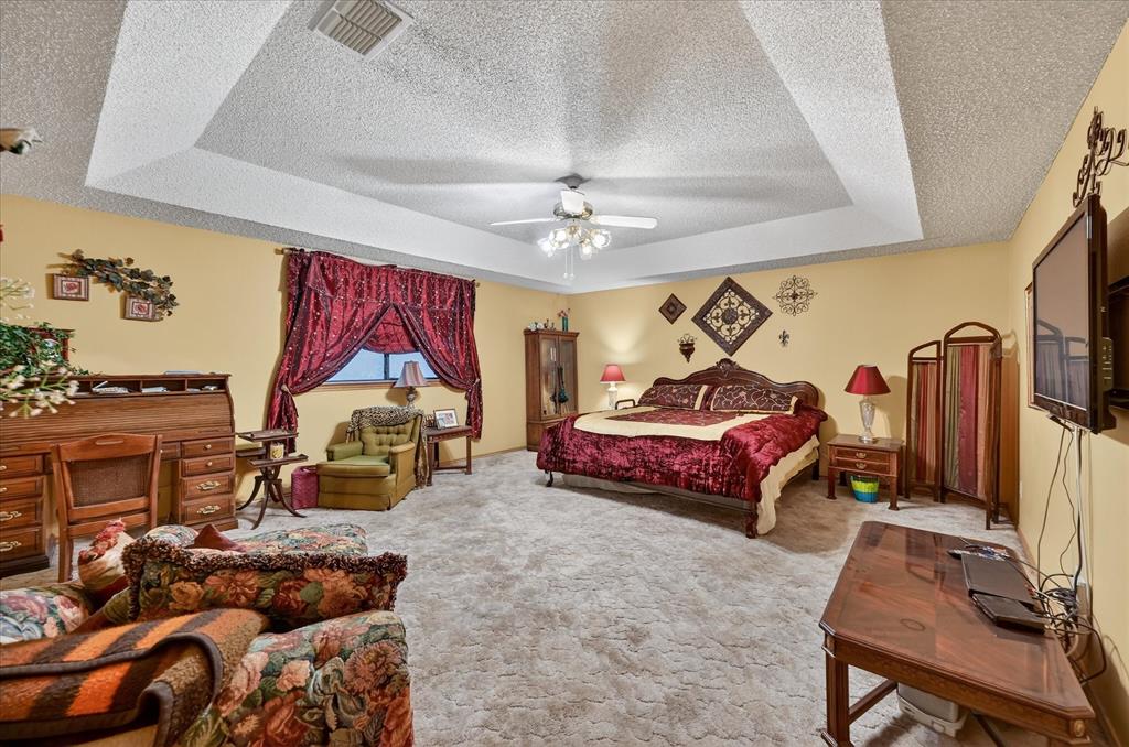 1605 Heather Court Cleburne, TX 76033 - Photo 12 of 33 a bedroom with furniture and a chandelier