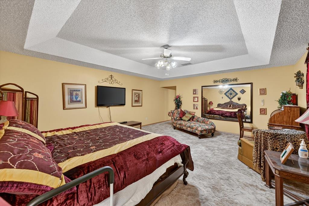 1605 Heather Court Cleburne, TX 76033 - Photo 13 of 33 a bedroom with a bed a couch and dresser