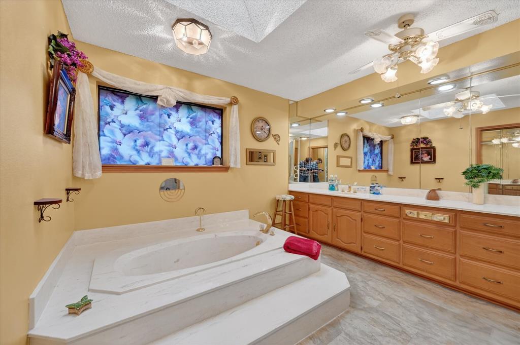 1605 Heather Court Cleburne, TX 76033 - Photo 14 of 33 a spacious bathroom with a double vanity sink and a mirror