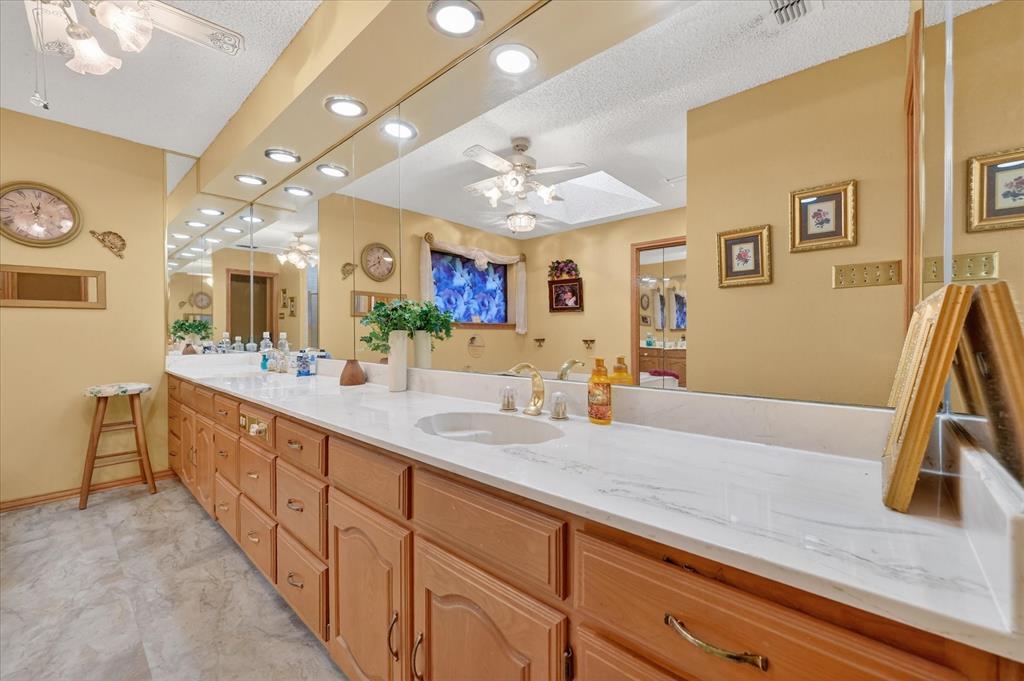 1605 Heather Court Cleburne, TX 76033 - Photo 15 of 33 a spacious bathroom with a granite countertop sink a mirror and a shower