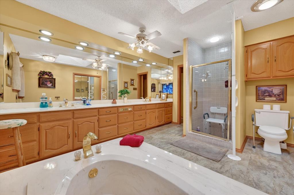 1605 Heather Court Cleburne, TX 76033 - Photo 16 of 33 a spacious bathroom with a sink a vanity and a mirror