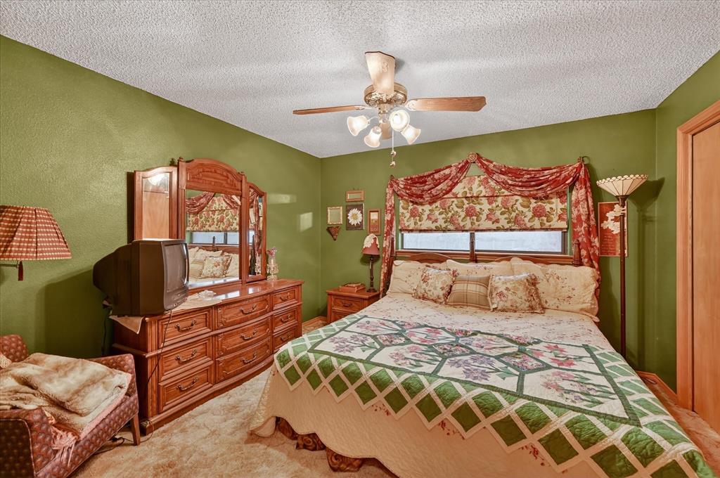 1605 Heather Court Cleburne, TX 76033 - Photo 20 of 33 a bedroom with a bed and wooden floor