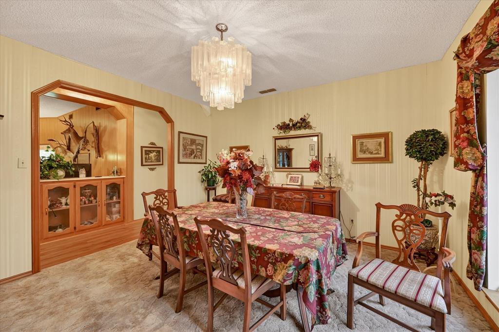 1605 Heather Court Cleburne, TX 76033 - Photo 21 of 33 a view of a dining room with furniture and chandelier