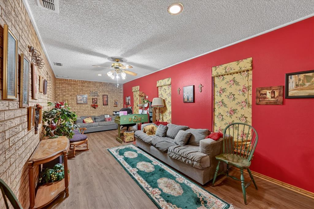 1605 Heather Court Cleburne, TX 76033 - Photo 24 of 33 a living room with furniture and a potted plant