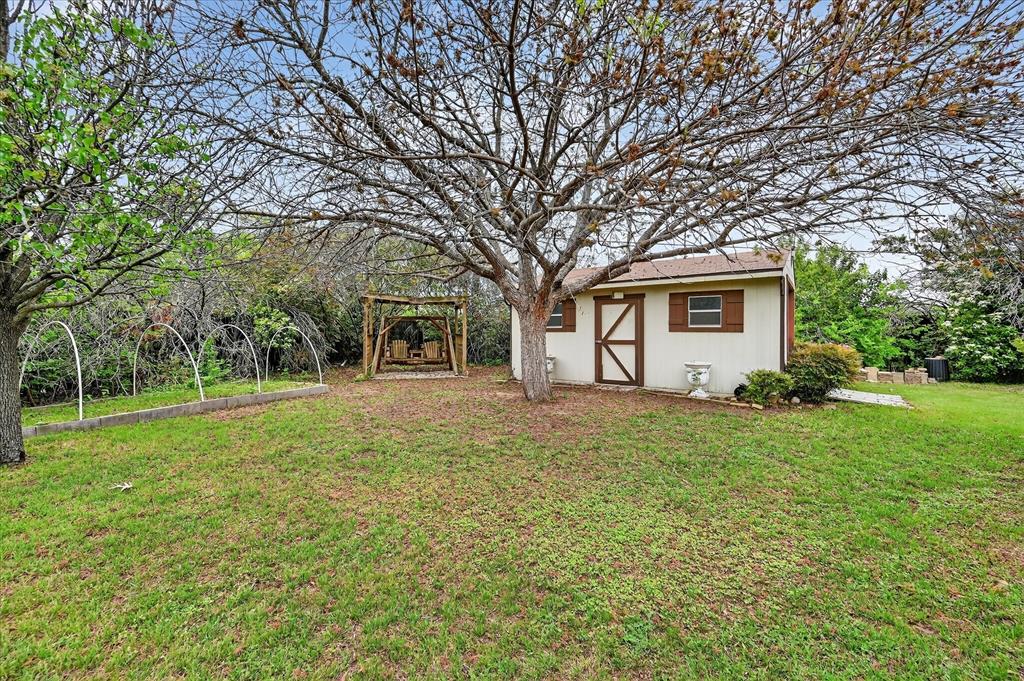 1605 Heather Court Cleburne, TX 76033 - Photo 27 of 33 a front view of a house with a garden