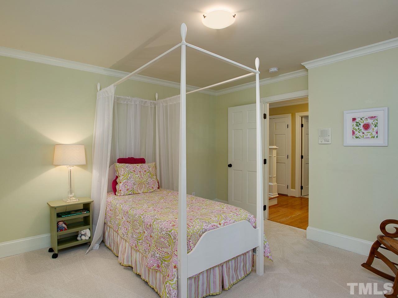 10300 Grafton Road Raleigh, NC 27615 - Photo 14 of 30 a bedroom with a bed and a chandelier