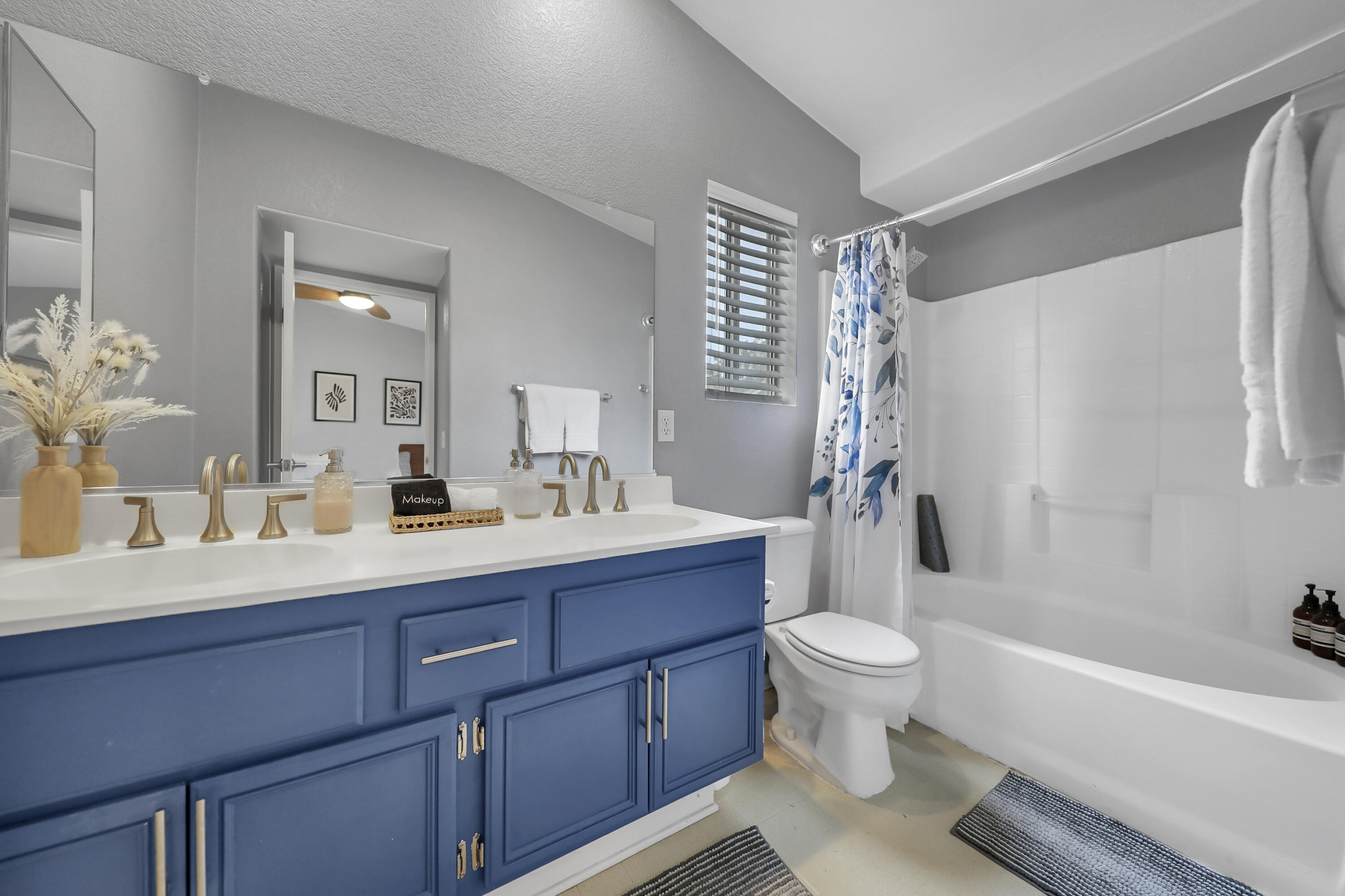 80490 Paseo Tesoro Indio, CA 92201 - Photo 13 of 28 a bathroom with a sink a toilet a mirror a vanity and shower