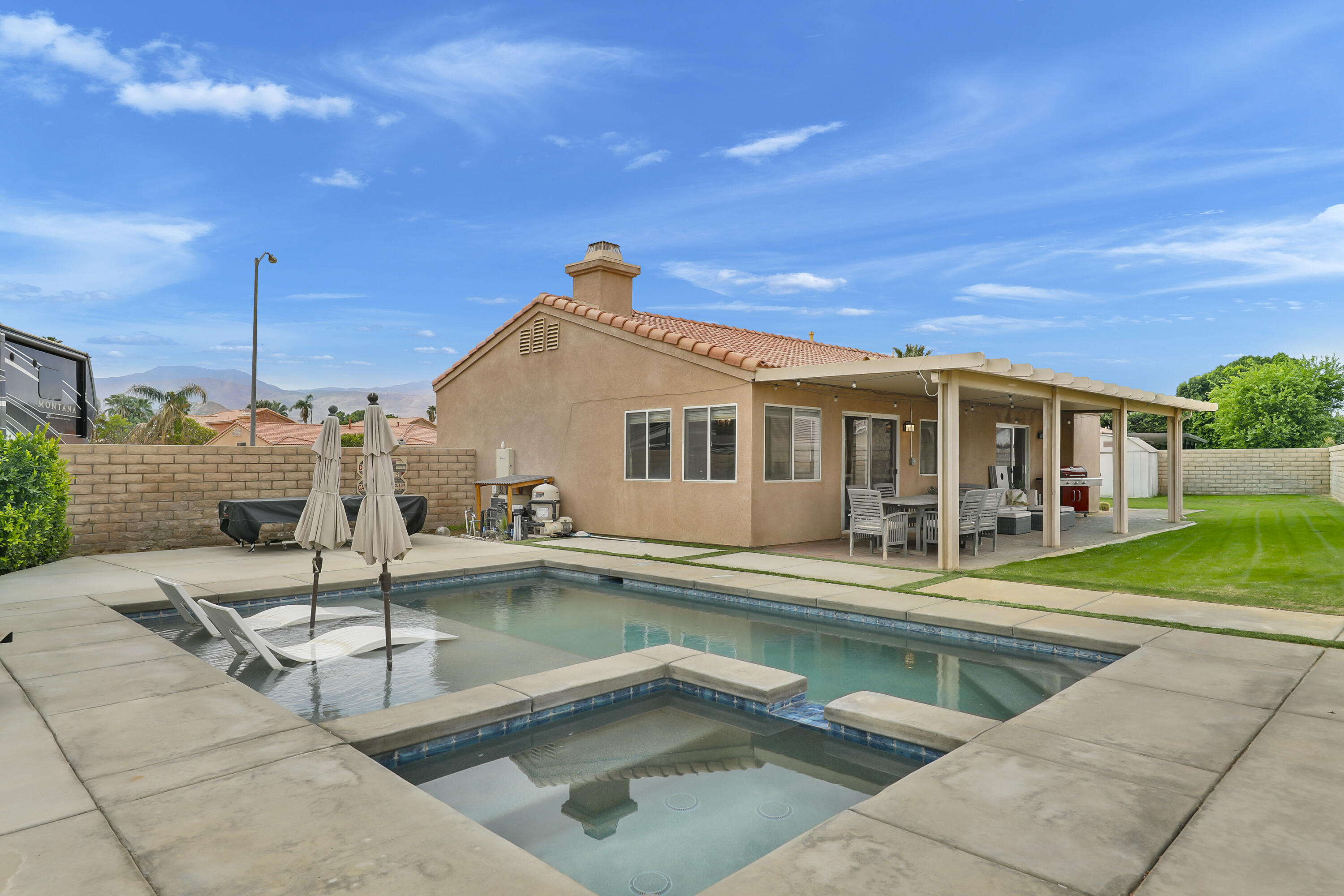 80490 Paseo Tesoro Indio, CA 92201 - Photo 2 of 28 a view of a house with pool and chairs