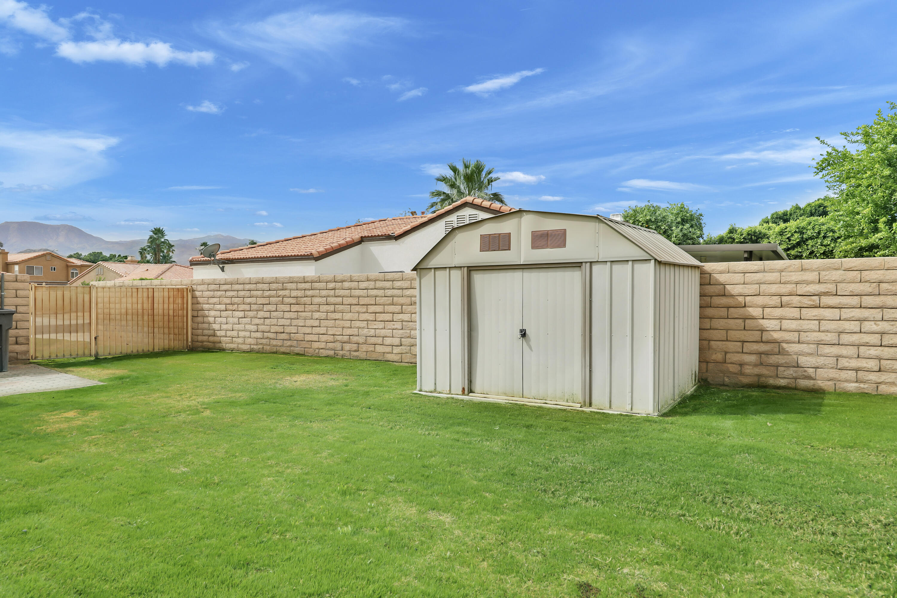 80490 Paseo Tesoro Indio, CA 92201 - Photo 25 of 28 a view of a backyard with barn plants and large tree