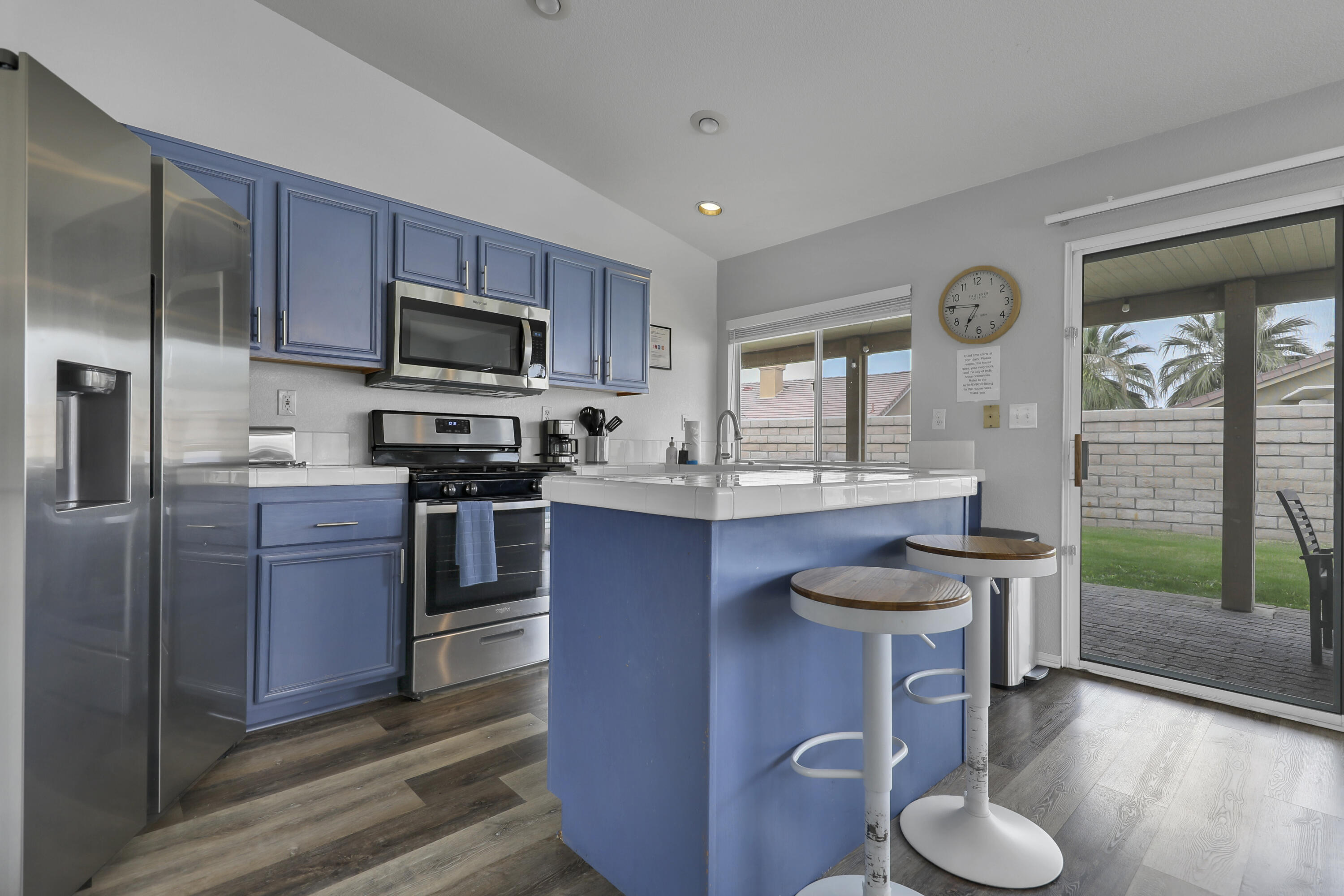 80490 Paseo Tesoro Indio, CA 92201 - Photo 9 of 28 a kitchen with stainless steel appliances granite countertop a stove a sink dishwasher a microwave oven and a refrigerator with wooden floor