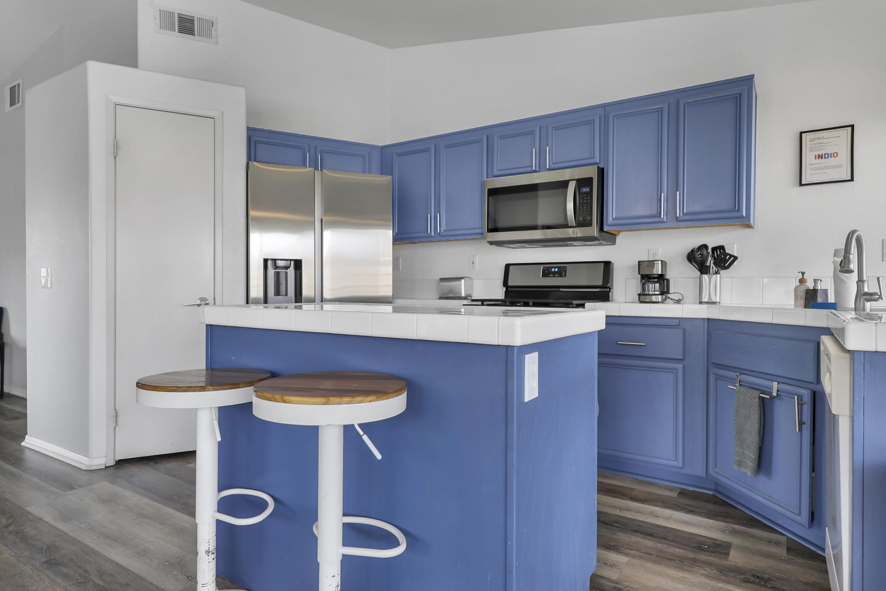 80490 Paseo Tesoro Indio, CA 92201 - Photo 10 of 28 a kitchen with stainless steel appliances granite countertop a sink stove and microwave