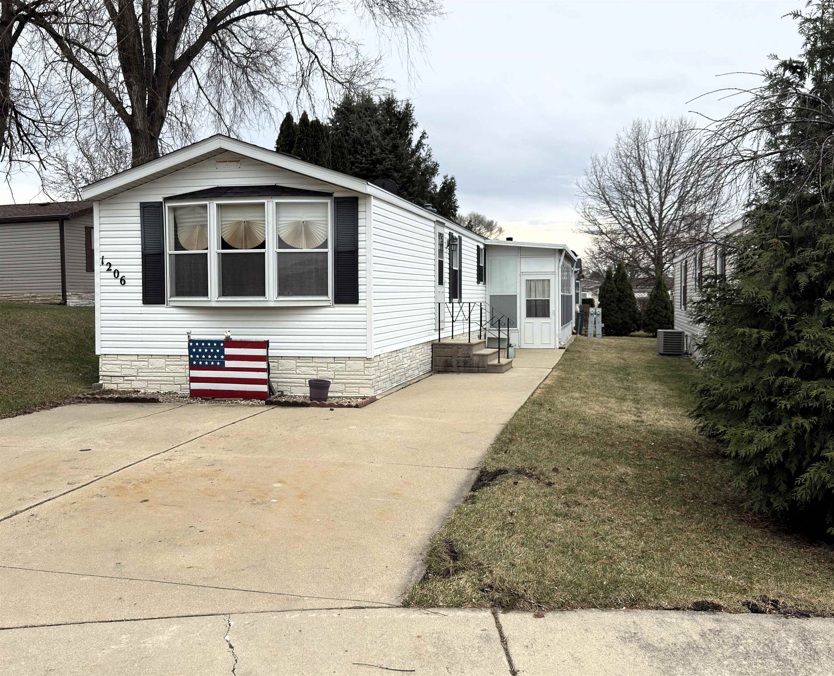 1206 Spring Circle Belvidere, IL 61008 - Photo 1 of 16 a front view of a house with a yard