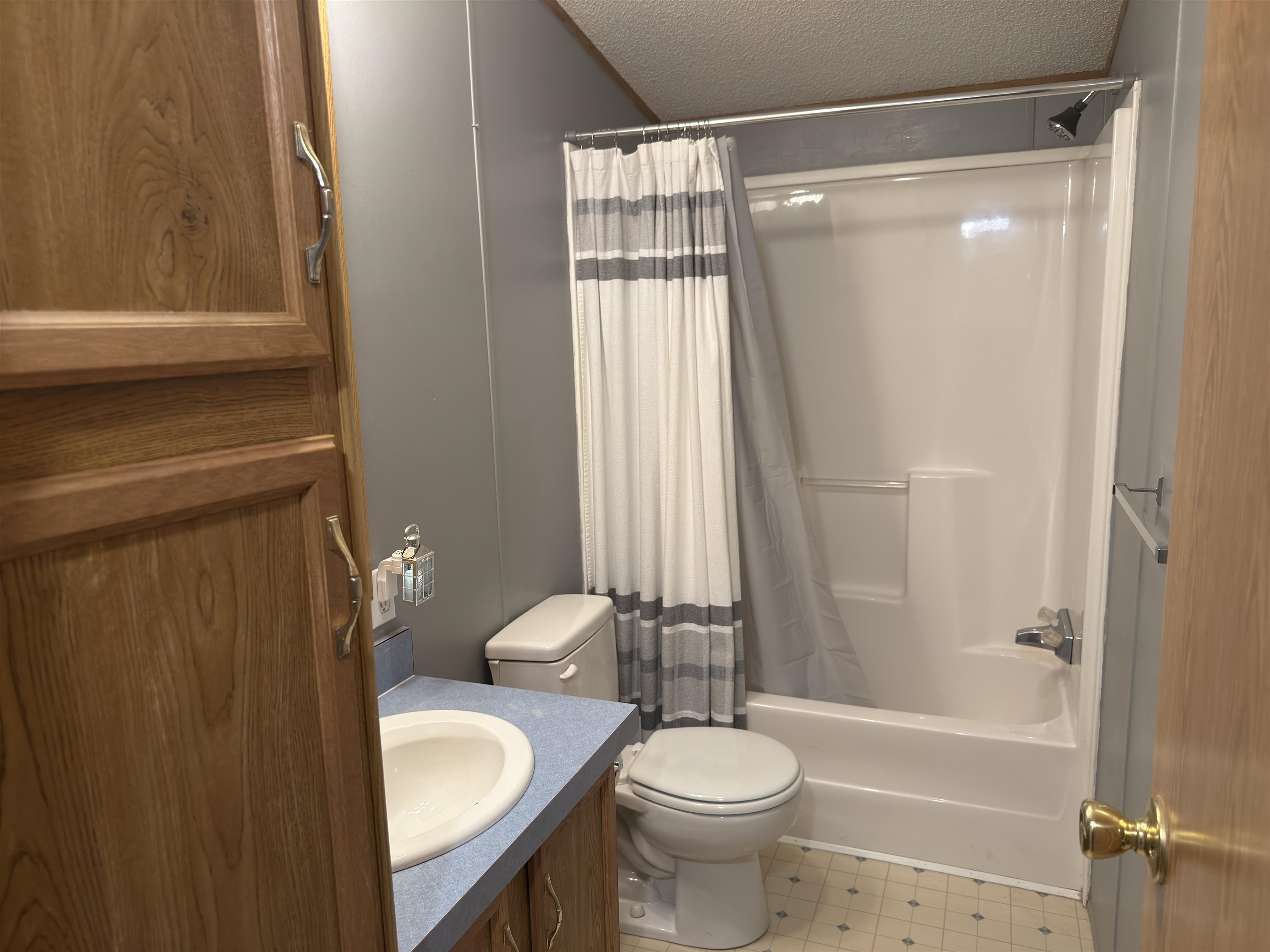 1206 Spring Circle Belvidere, IL 61008 - Photo 11 of 16 a bathroom with a granite countertop bathtub shower sink vanity and toilet