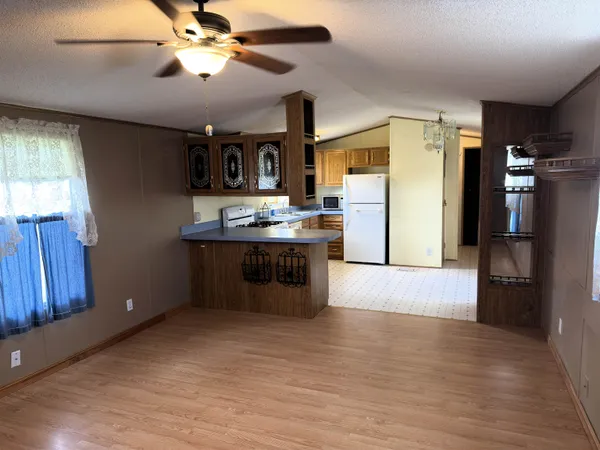 a kitchen with stainless steel appliances granite countertop a refrigerator a stove and a refrigerator