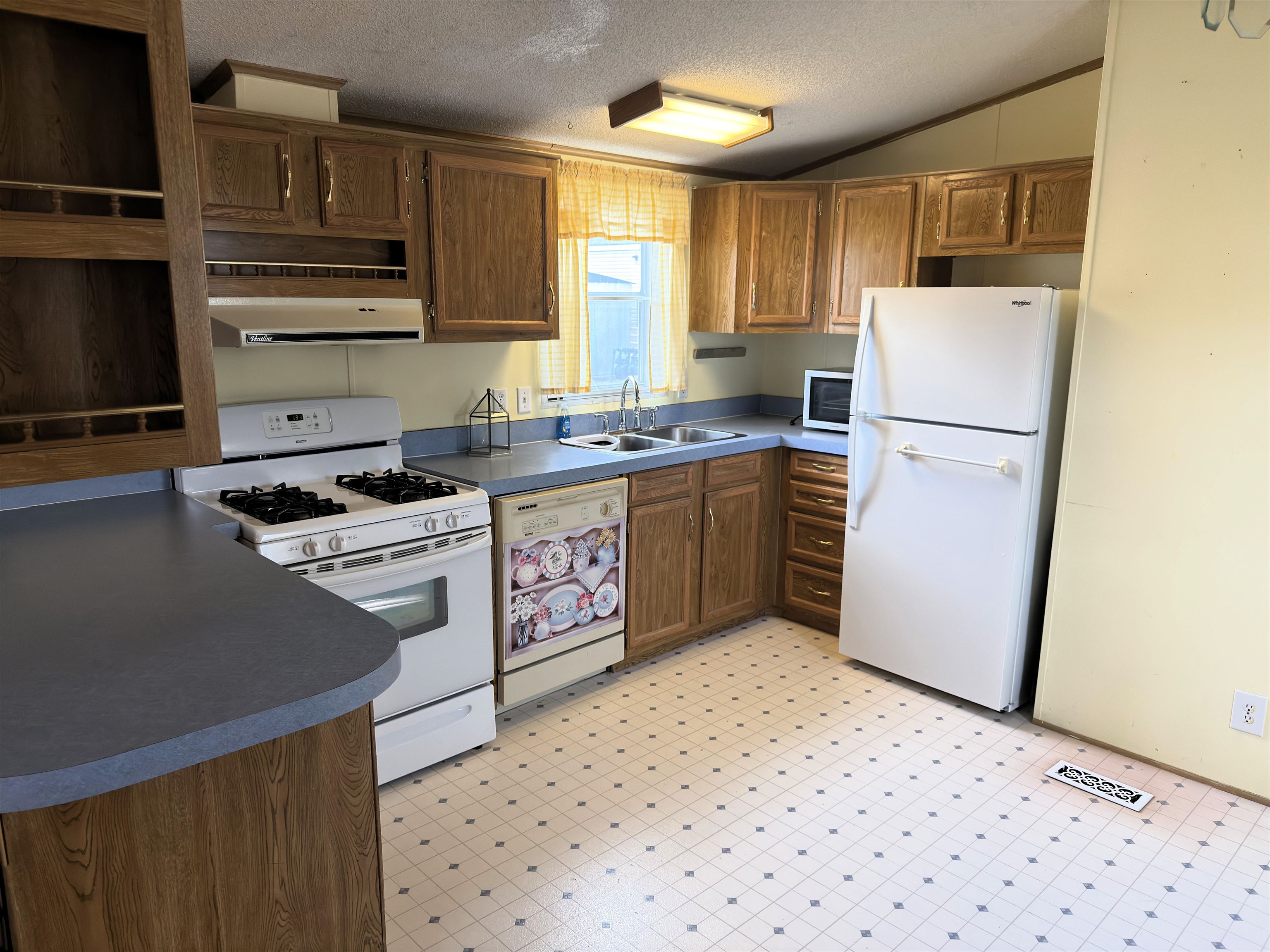 1206 Spring Circle Belvidere, IL 61008 - Photo 4 of 16 a kitchen with stainless steel appliances granite countertop a refrigerator stove a sink dishwasher and wooden cabinets