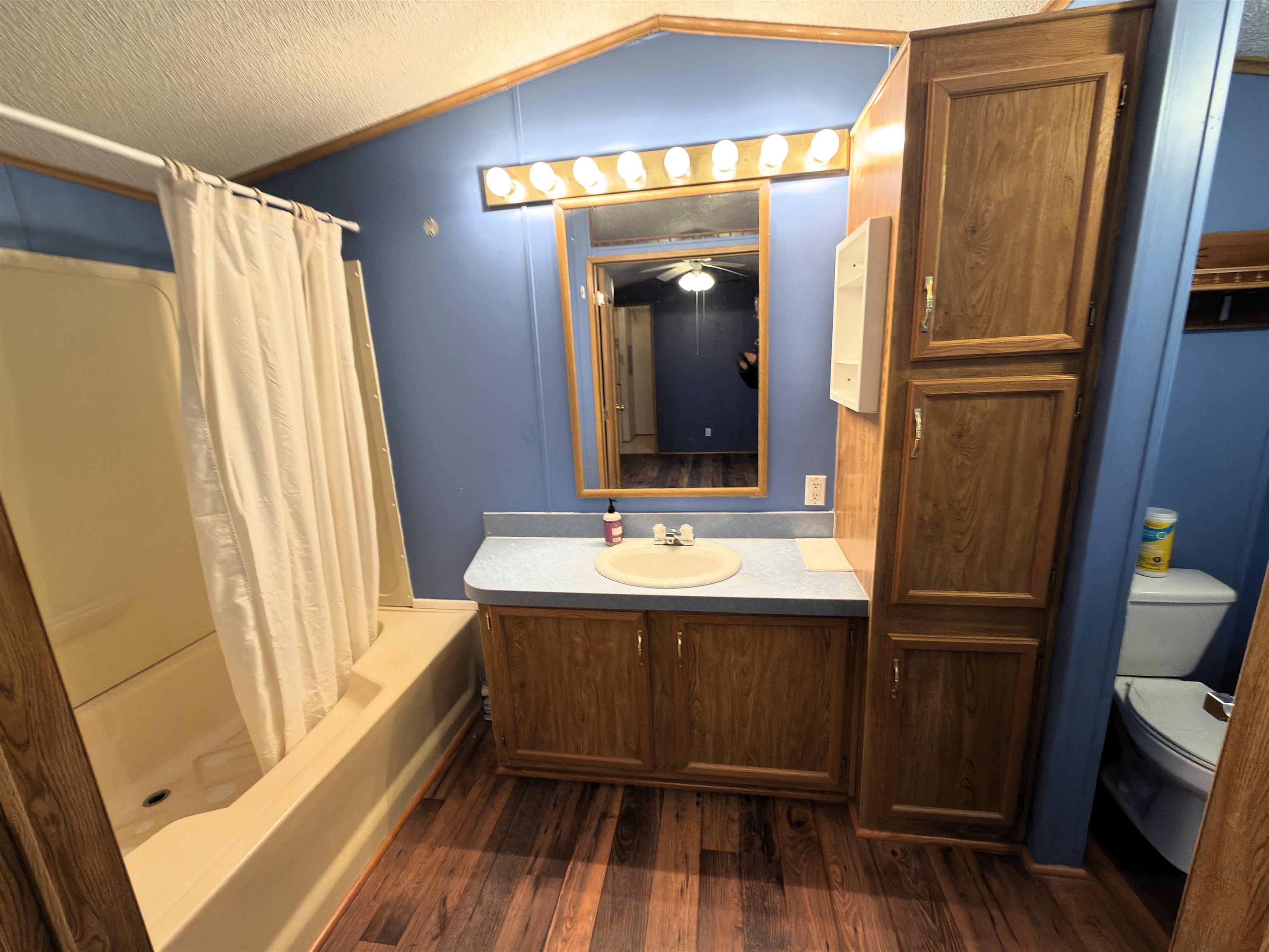 1206 Spring Circle Belvidere, IL 61008 - Photo 6 of 16 a bathroom with a sink a mirror and a shower