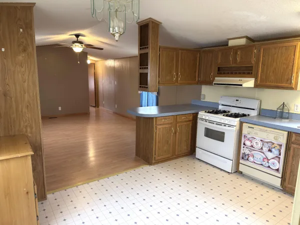 a kitchen with stainless steel appliances a stove a sink and a refrigerator with cabinets