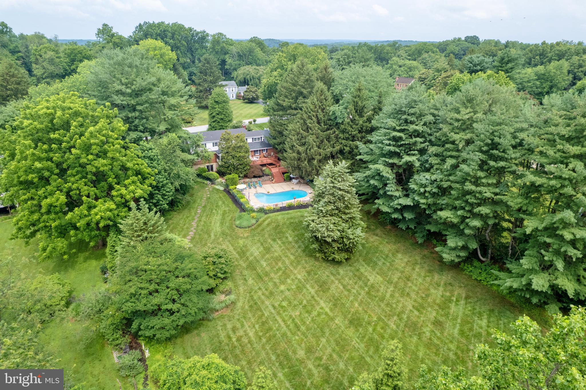 13713 Harcum Road Phoenix, MD 21131 - Photo 2 of 101 a view of a lush green forest with trees and some houses