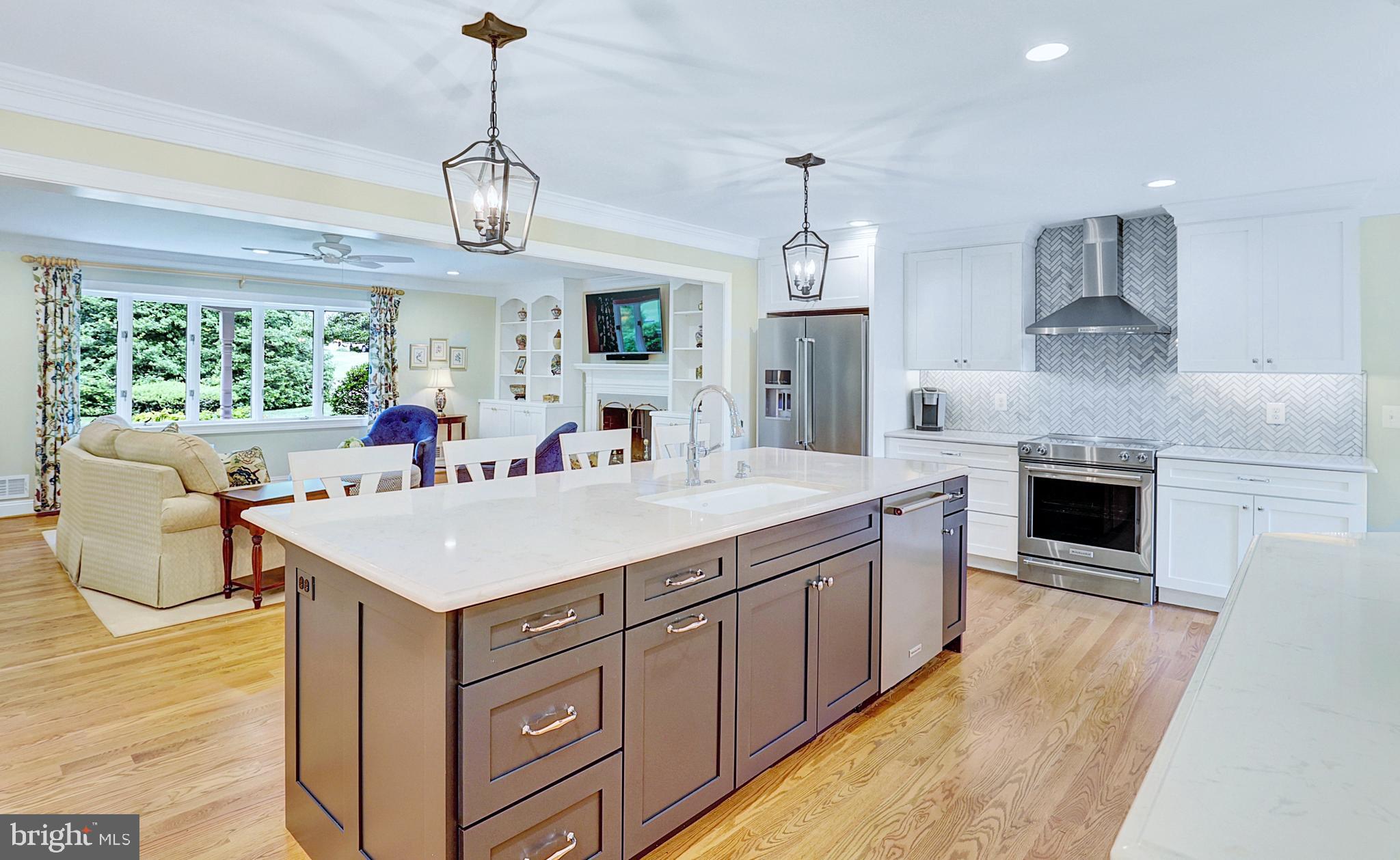 13713 Harcum Road Phoenix, MD 21131 - Photo 21 of 101 a large kitchen with kitchen island a large counter space a sink appliances and cabinets