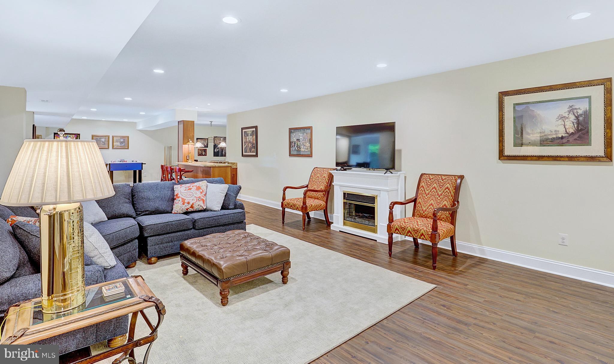 13713 Harcum Road Phoenix, MD 21131 - Photo 54 of 101 a living room with furniture a flat screen tv and a table
