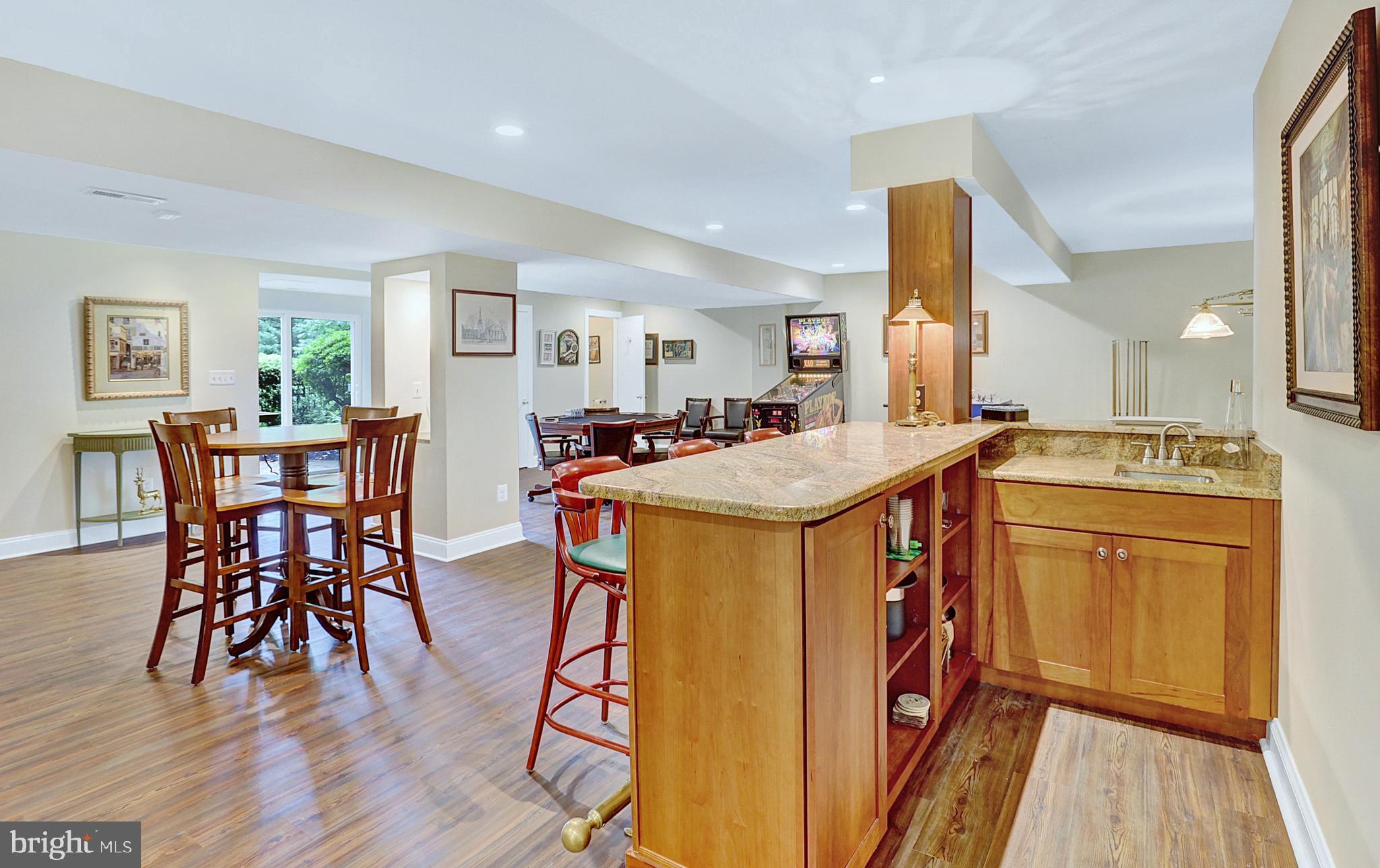 13713 Harcum Road Phoenix, MD 21131 - Photo 55 of 101 a open kitchen with stainless steel appliances granite countertop a table chairs and a refrigerator