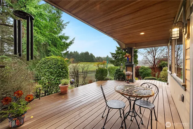 a patio with table and chairs and potted plants