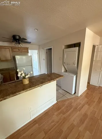 a spacious bathroom with a granite countertop sink and a mirror