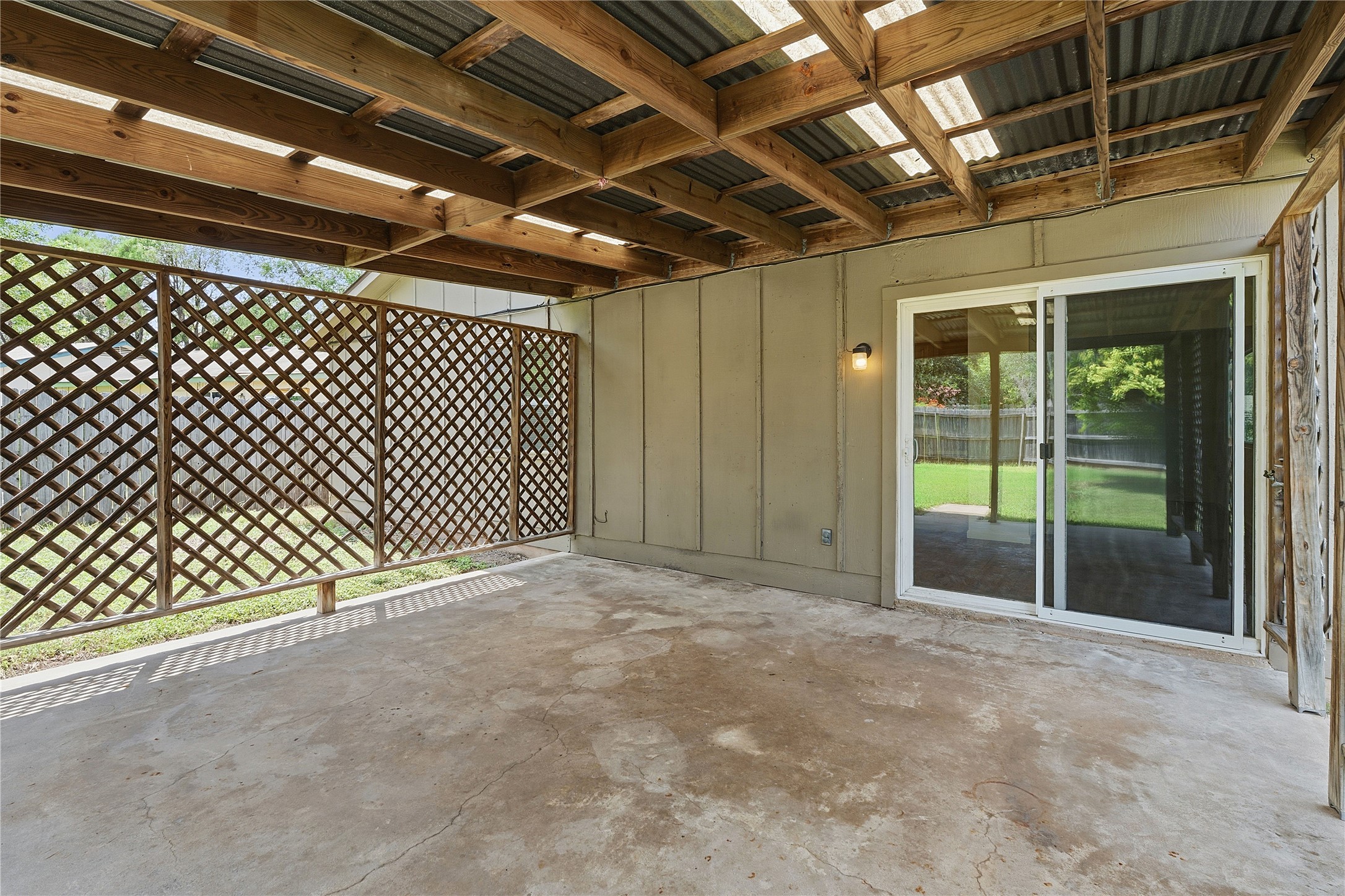 6205 Shadow Bend Austin, TX 78745 - Photo 27 of 31 A spacious covered patio provides a delightful outdoor living area overlooking the yard.