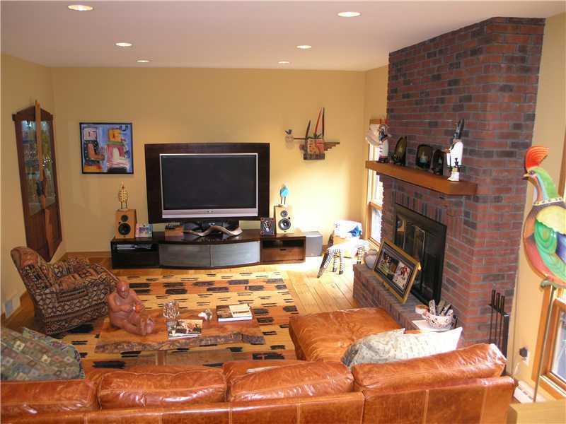 129 Riding Trail Lane Fox Chapel, PA 15215 - Photo 12 of 25 Family Room. The sunken Family Room is open to the Kitchen and offers a cozy fireplace with brick hearth, hardwood flooring, recessed lighting and a glass fronted bar area with glass shelving and accent lighting.