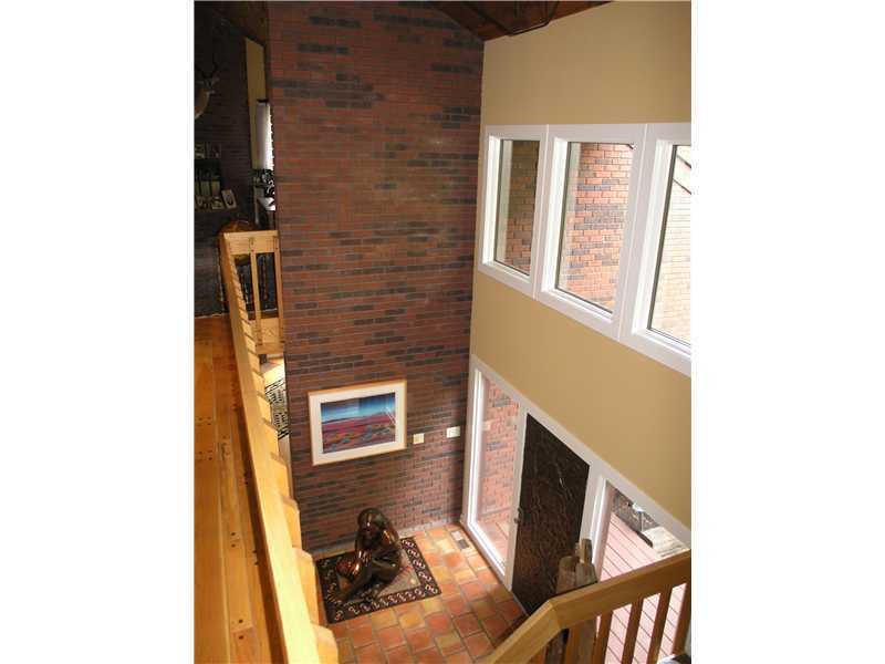129 Riding Trail Lane Fox Chapel, PA 15215 - Photo 7 of 25 Entry/Foyer. View of Entry from second floor highlighting windows and exposed brick.