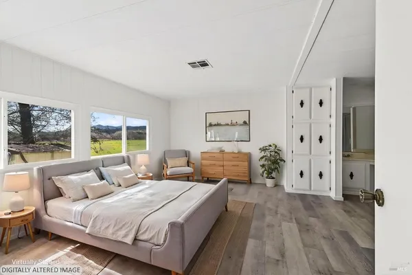 a spacious bedroom with a bed and a large window
