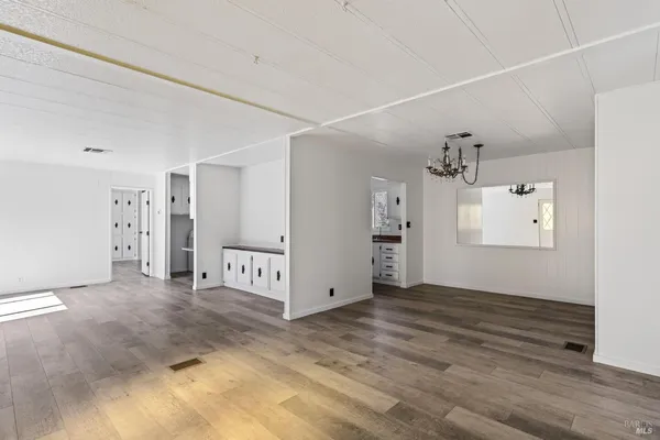 a view of a room with wooden floor