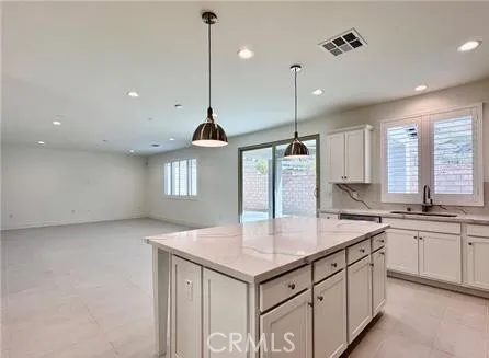 a kitchen with a stove a sink a center island and a refrigerator