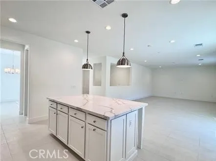 a kitchen with a sink a center island and a wooden floor