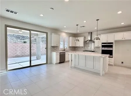 a kitchen with white cabinets and refrigerator
