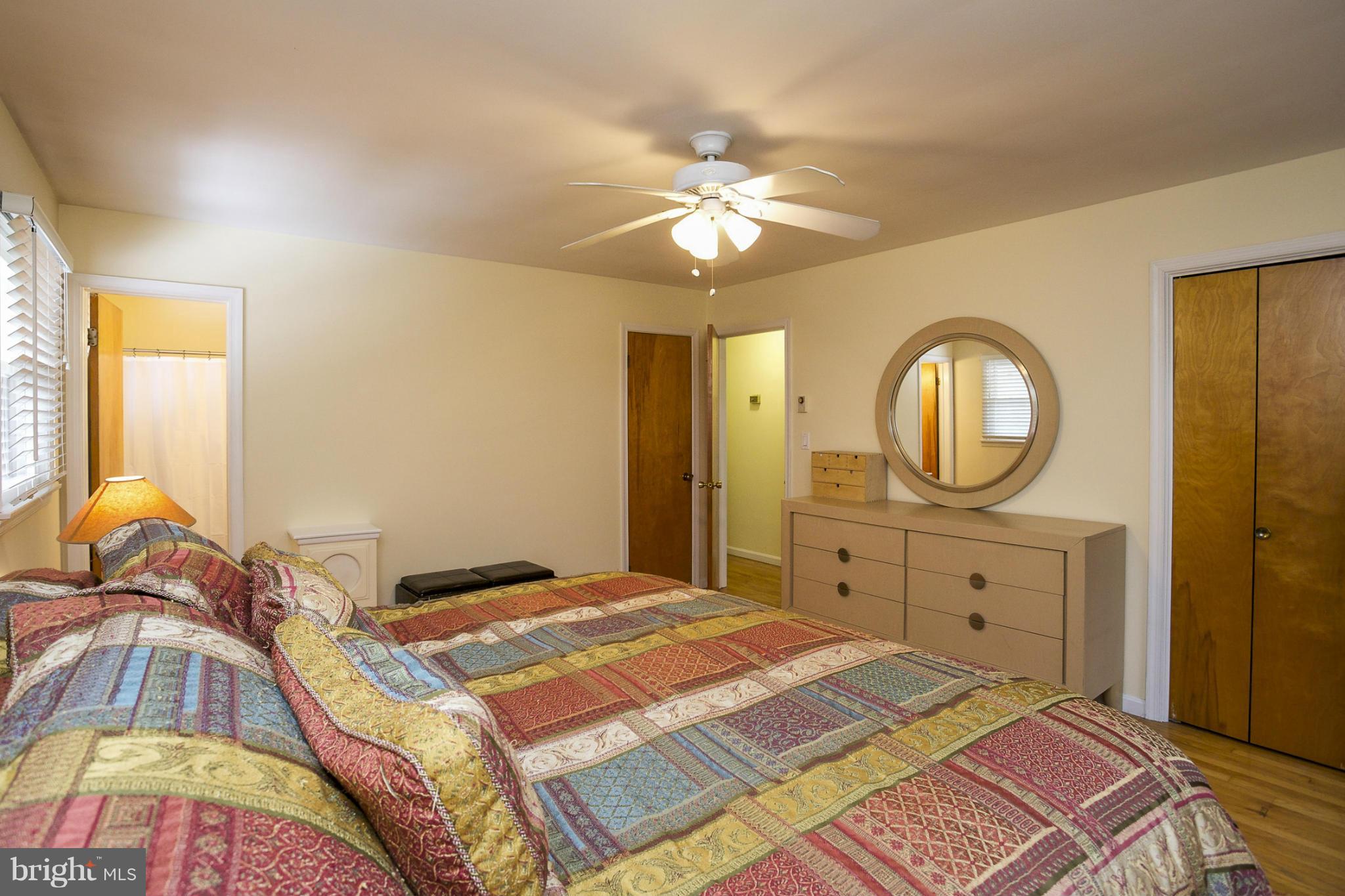 1712 Parkvue Road Fallston, MD 21047 - Photo 13 of 29 a bedroom with a bed a mirror on the dresser and a chandelier