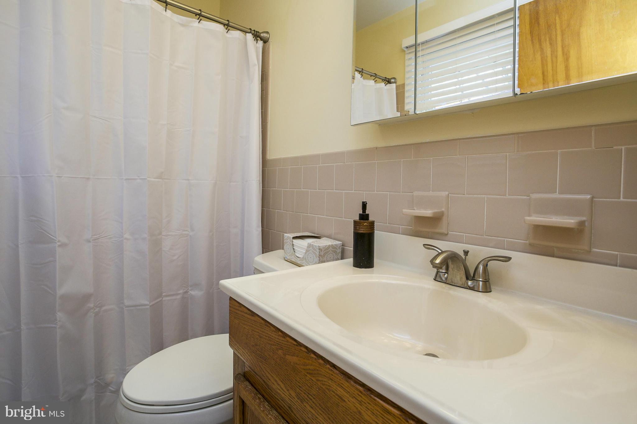 1712 Parkvue Road Fallston, MD 21047 - Photo 14 of 29 a bathroom with a sink a toilet and shower curtain