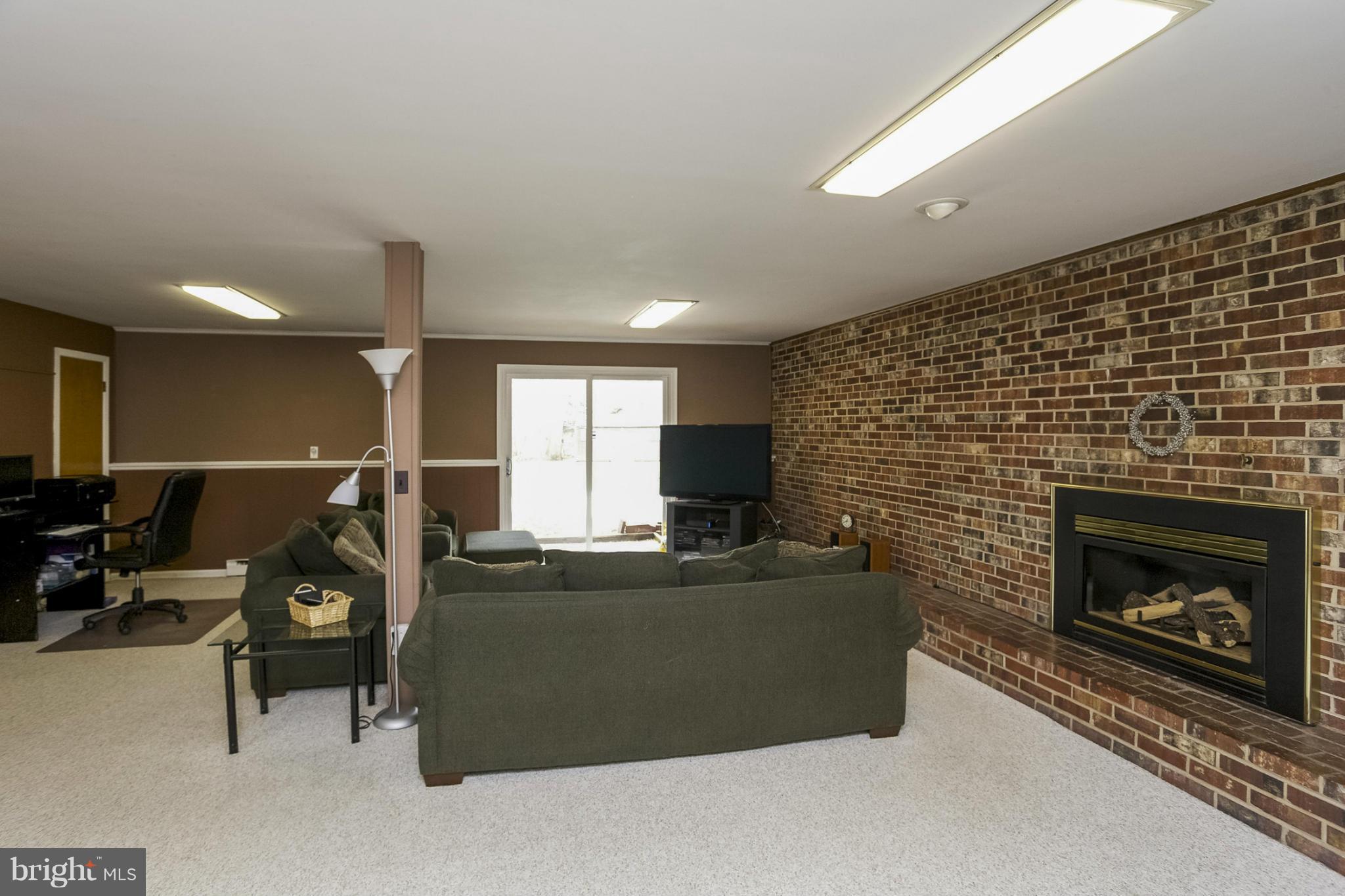 1712 Parkvue Road Fallston, MD 21047 - Photo 22 of 29 a living room with furniture a flat screen tv and a fireplace