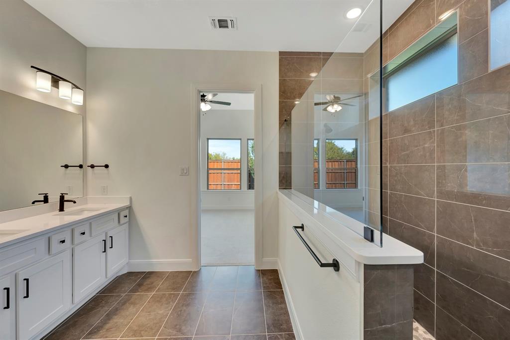2901 Long Trail Mansfield, TX 76063 - Photo 14 of 28 a bathroom with a double vanity sink and mirror