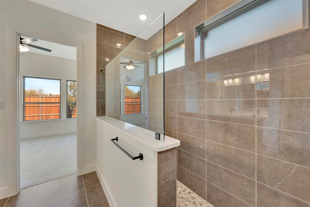 2901 Long Trail Mansfield, TX 76063 - Photo 15 of 28 a bathroom with a mirror and a shower