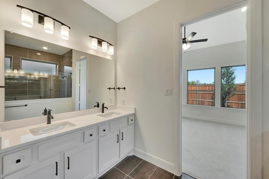 2901 Long Trail Mansfield, TX 76063 - Photo 16 of 28 a bathroom with double sink and a mirror